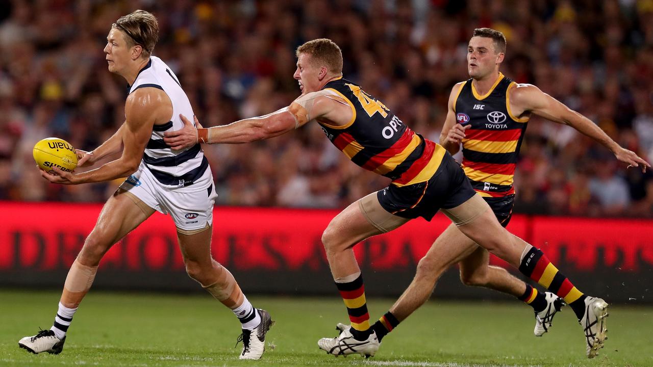 Rhys Stanley of the Cats is tackled by Reilly O'Brien of the Crows during the round 03 match at Adelaide Oval. Picture: James Elsby/AFL Photos/Getty Images