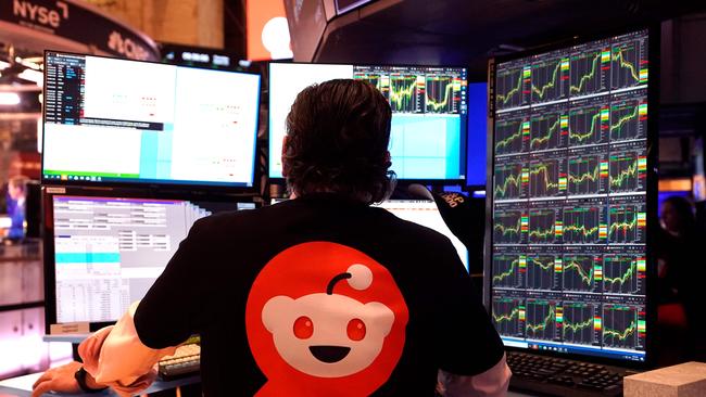 A trader on the floor of the NYSE with a Reddit T-shirt works after the opening bell. Picture: Timothy A. Clary/AFP