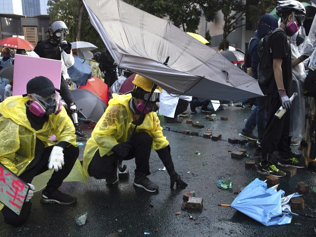 A Hong Kong police officer was hit in the leg by an arrow Sunday as authorities used tear gas and water cannons to try to repel protesters occupying a university. Picture: AP Photo