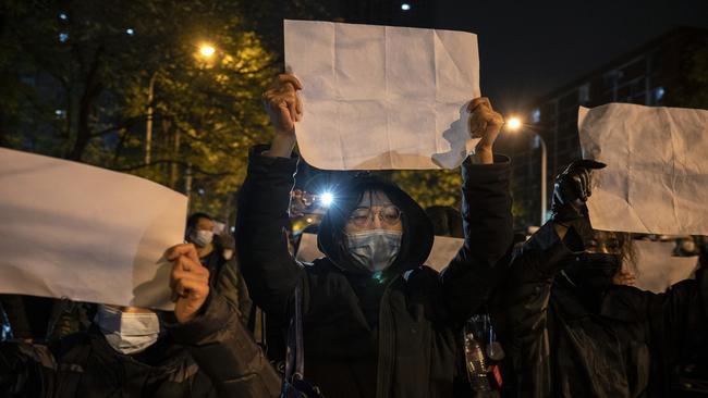 Protesters hold up a white piece of paper against censorship. Picture: Getty