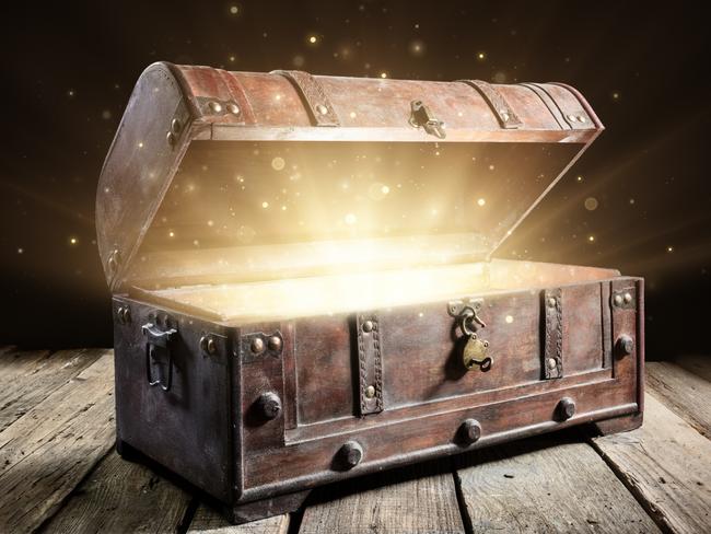 Treasure Chest - Open Ancient Trunk With Glowing Magic Lights In The Dark. Picture: istock