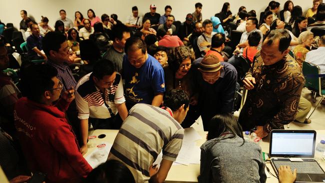 Relatives of missing Air Asia QZ8501 passengers gather during a meeting with officials at the crisis centre of Juanda International Airport Surabaya on December 28. Picture: Robertus Pudyanto