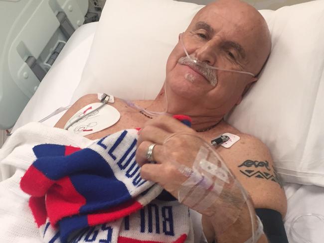 Bulldogs fan Rob McCarthy survived a heart attack which struck at the MCG moments before his team's Grand Final win.