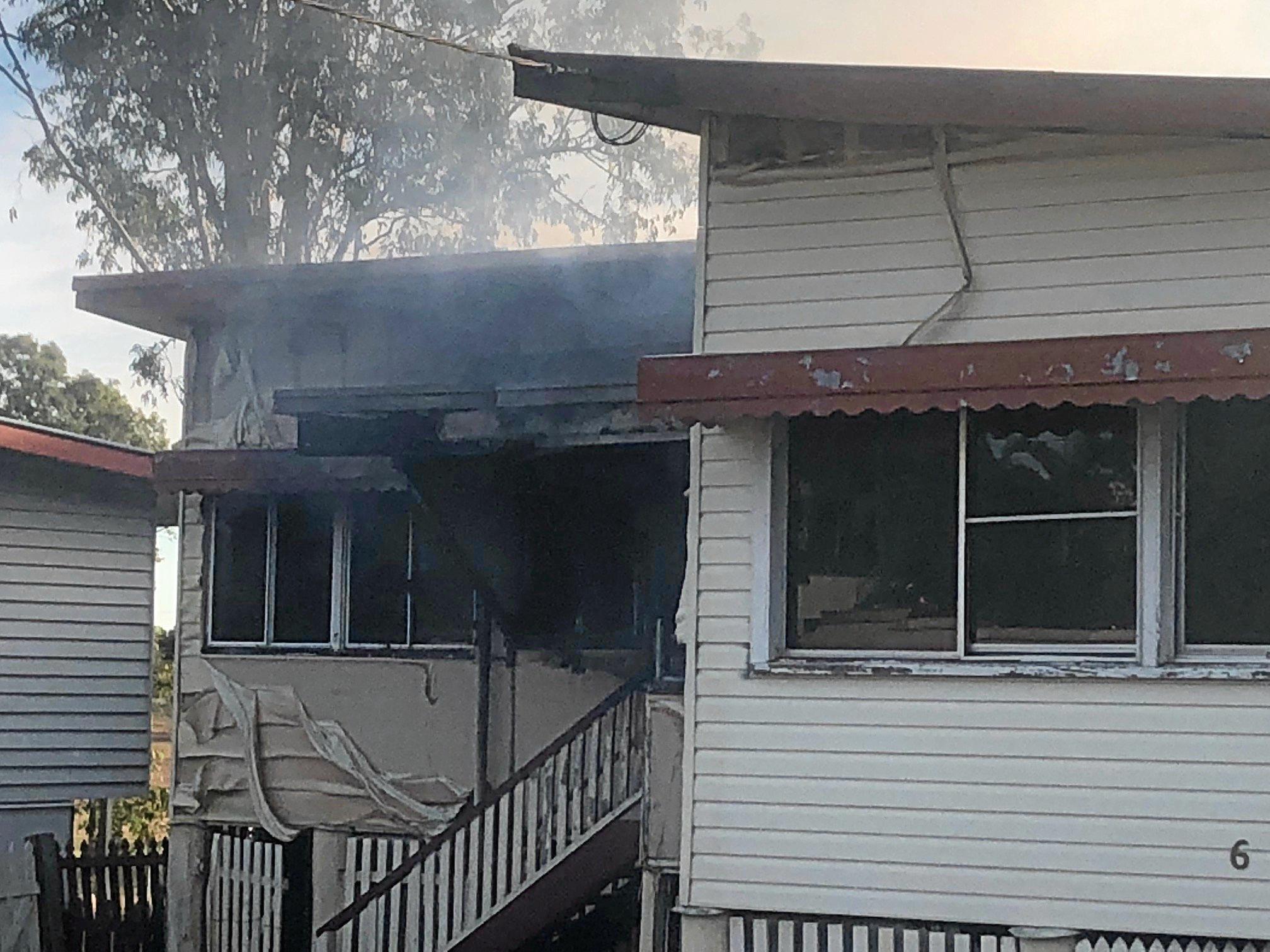 Firefighters at the scene of a house fire on Naughton St, Wandal, this afternoon. Reports indicate the top part of the house is gutted but firefighters are walking in through the front door.