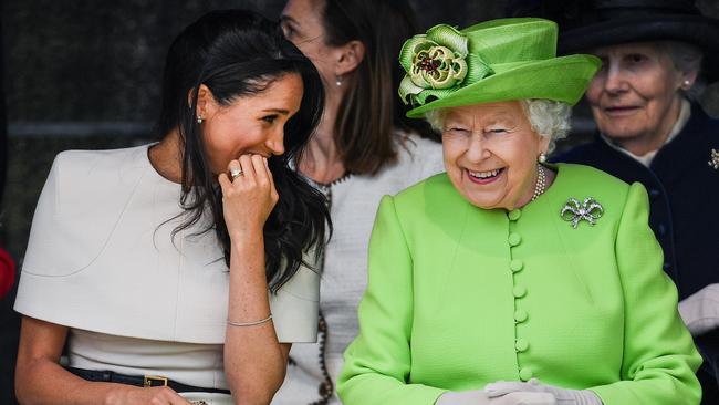 The late Queen Elizabeth II (right) speaks with Meghan, Duchess of Sussex, during a ceremony to open the new Mersey Gateway Bridge in 2018. Picture: Getty Images