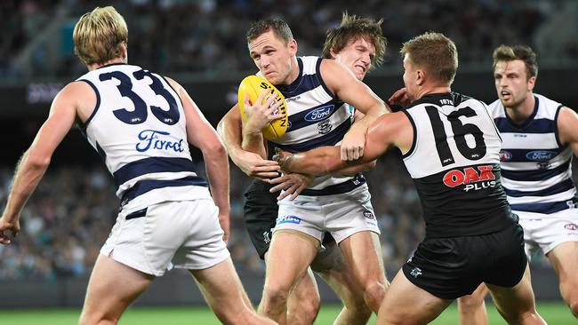 Joel Selwood (second from left) in action during the win against Port Adelaide.