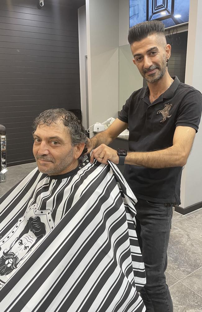 Cut Castle owner Shasab Mobarak giving a haircut to Donny Matera who was visiting family from Sydney. Picture: Aaron Goodwin