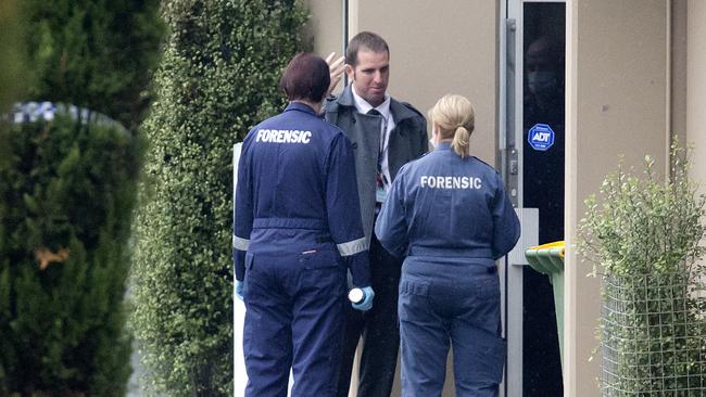 A detective and forensic officers at the scene of where Dean McGrath’s body was found in Braeside. Picture: Sarah Matray