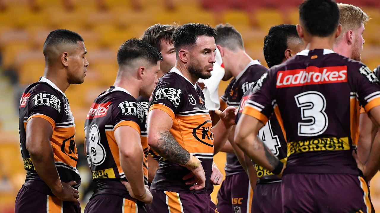 The Broncos stand dejected following a Roosters try.