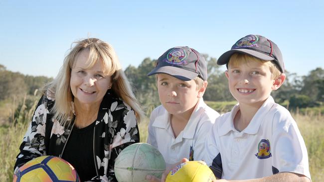 Council has allocated money in the budget for planning work to start on Griffin sports complex. Cr Julie Greer with Austin and Theo Tsingos (griffin) on the site of the new ovals. Picture: Chris Higgins