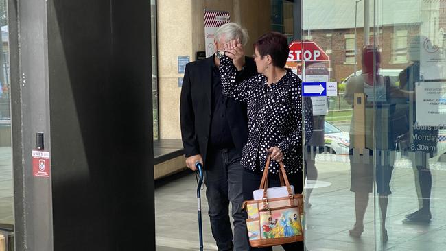 Harold Ernest Lawrence, 59, hid behind his wife as they left Ipswich District Court on Monday after he was sentenced for child sex offences.