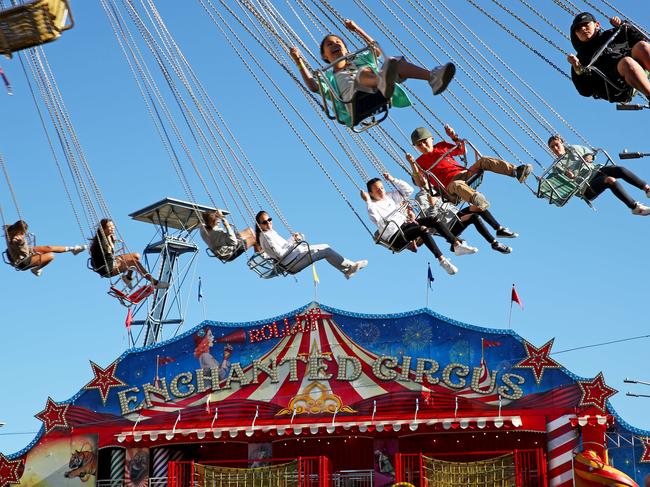 Show goers ride the Wave Swinger today. Picture: Toby Zerna