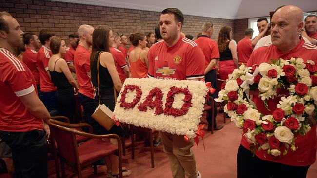 2017: Dominic Delaney carriers a 'Dad' flower bed at the funeral of Carl Delaney held at Darwin Funeral Services. More than 300 family and friends were in attendance.