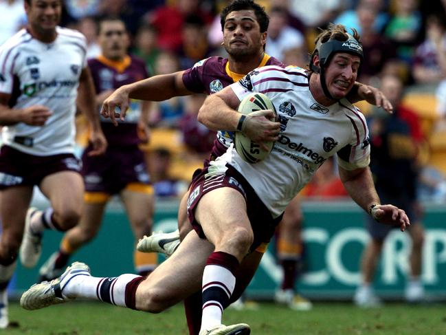 NRL.Round 9.Brisbane Broncos v Manly Sea Eagles at Suncorp Stadium.Steve Menzies beats the grasping tackle of Karmichael Hunt to score during Manly's victory 30-12.