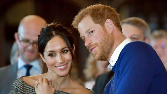 (FILES) In this file photo taken on January 18, 2018 Britain's Prince Harry and his fiancée US actress Meghan Markle watch a dance performance by Jukebox Collective during a visit at Cardiff Castle in Cardiff, south Wales on January 18, 2018, for a day showcasing the rich culture and heritage of Wales. Meghan Markle once struggled for roles but the US actress has now landed the biggest part of all as she prepares to marry Prince Harry on May 19, 2018 and become the newest face in Britain's royal family. / AFP PHOTO / POOL / Ben Birchall