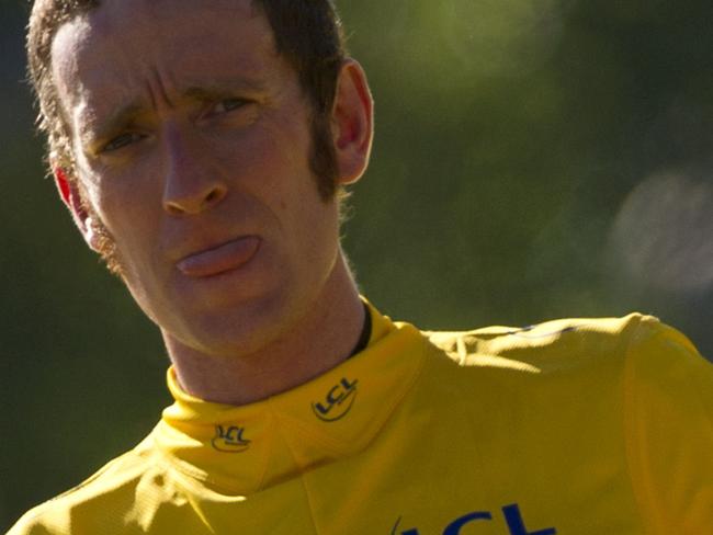 Overall leader's yellow jersey and British Bradley Wiggins, celebrates on the podium at the end of the 120 km and last stage of the 2012 Tour de France cycling race starting in Rambouillet and finishing in the famous Paris-Champs-Elysees Avenue, on July 22, 2012. AFP PHOTO / LIONEL BONAVENTURE