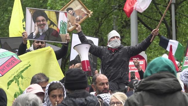 Protesters in Melbourne on September 29 are seen displaying Hezbollah flags and portraits of the terror group’s slain chief, Hassan Nasrallah. Picture: Valeriu Campan