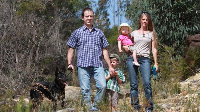 Ben Lynch with family Emily, Edyta and Cassey near where the family saw a snake at their Middle Dural property. Picture: Carmela Roche