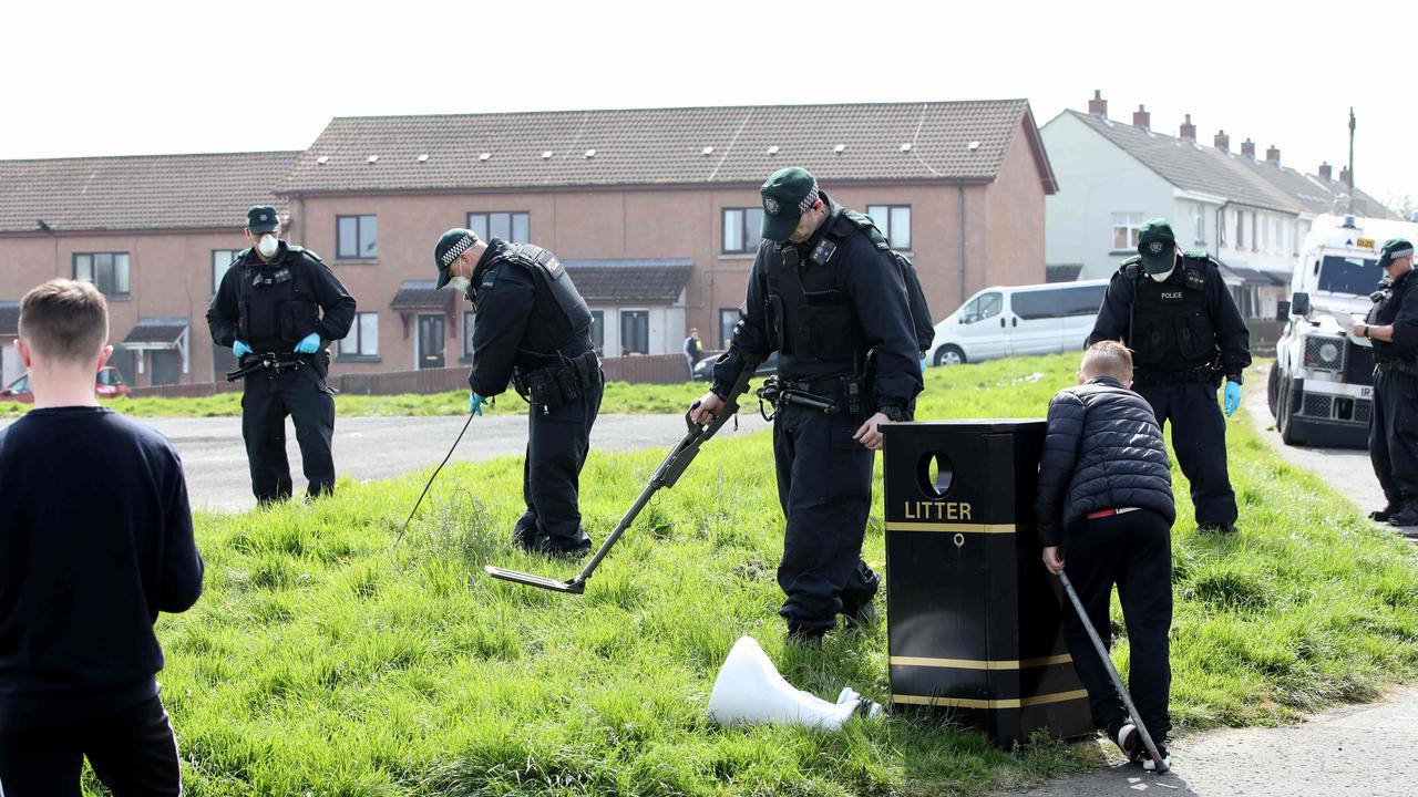 Police officers search the scene where Lyra McKee was fatally shot. Picture: Paul Faith/AFP