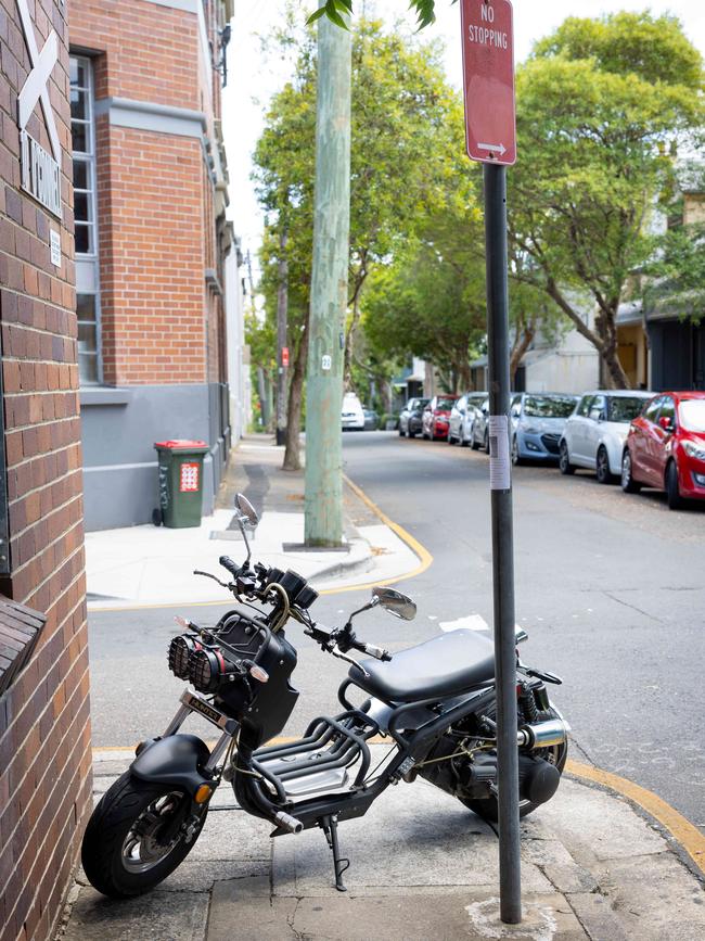 A motorbike parked on the pavement in Newtown.