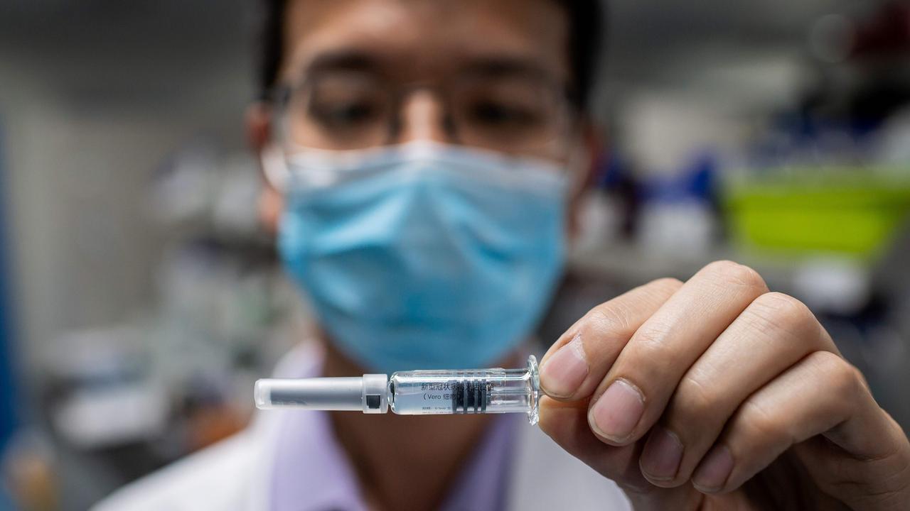 An engineer shows an experimental vaccine for the COVID-19 coronavirus that was tested at the Quality Control Laboratory at the Sinovac Biotech facilities in Beijing. Picture: Nicolas Asfouri/AFP.