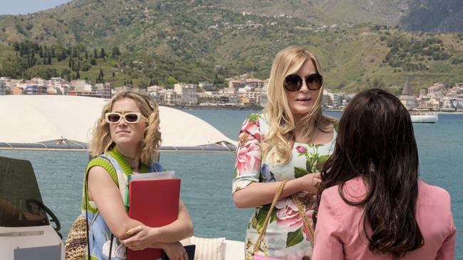 Tanya McQuoid (Jennifer Coolidge), centre, arrives for her second stay at the White Lotus Resort and Spa in Sicily, with assistant Portia (Haley Lu Richardson), left, in tow. Picture: Binge/HBO
