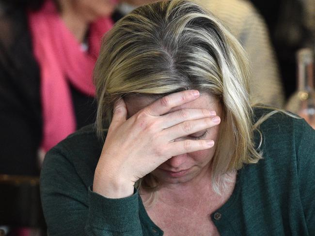 A Clinton fan with her head in her hand at an election party at the Kingston Hotel in Melbourne. Picture: Julian Smith