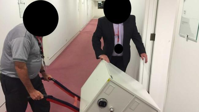 ASIO staff deliver a safe to the ABC’s Parliament House bureau this morning to secure the Cabinet files. Picture: ABC News