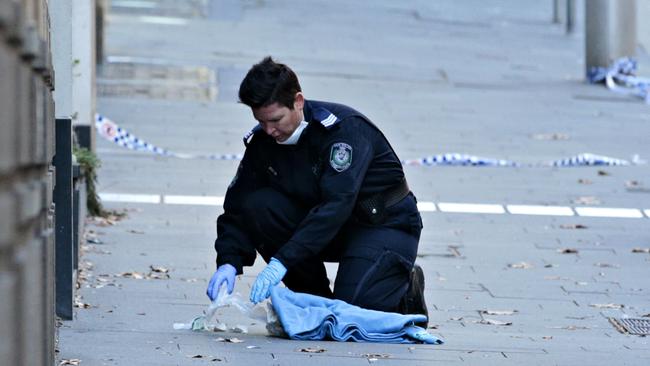 Police cleaning up the crime scene where Hamze was killed. Picture: Adam Yip
