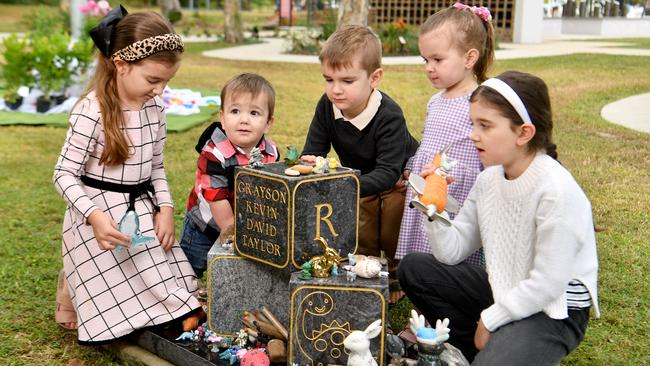 Scarlet, 7, Carson, 1, Cooper, 5, Aubrey, 2, and Ruby Taylor, 9, at the headstone for Grayson at the Forever Garden at the Belgian Gardens Cemetery. Picture: Evan Morgan