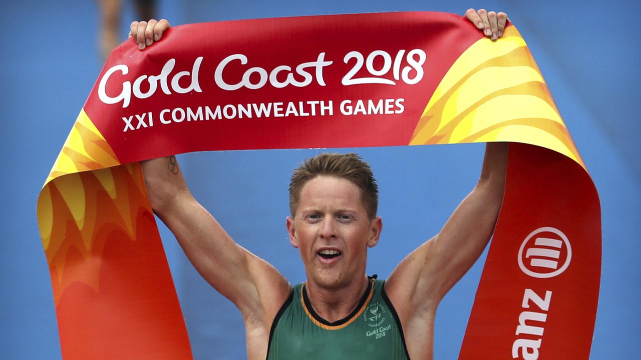 Henri Schoeman celebrates after crossing the finish line to win the mens triathlon.