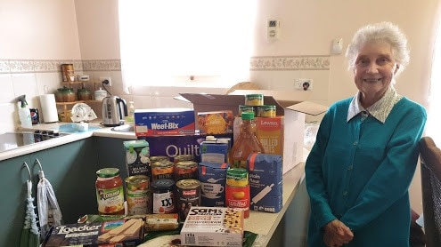 Lillian Scholtz with her care package goodies.