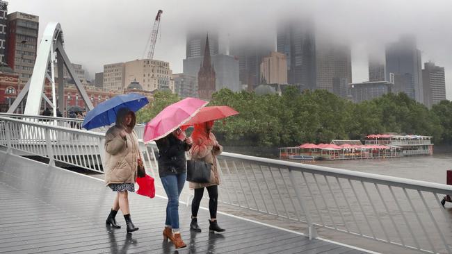 Rain sweeps across Melbourne and parts of Victoria on Saturday. Picture: David Crosling