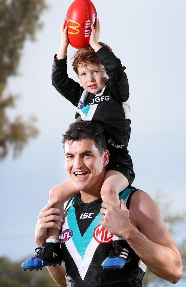 Jack, 3, takes a screamer over his dad Tom Rockliff’s shoulders. Picture Sarah Reed.