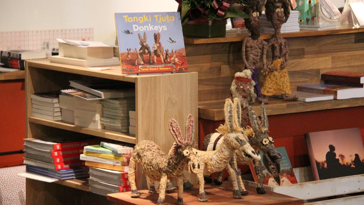 Tjanpi Desert Weavers' book Tangki Tjuta beside characters which were weaved for it. Picture: Gera Kazakov