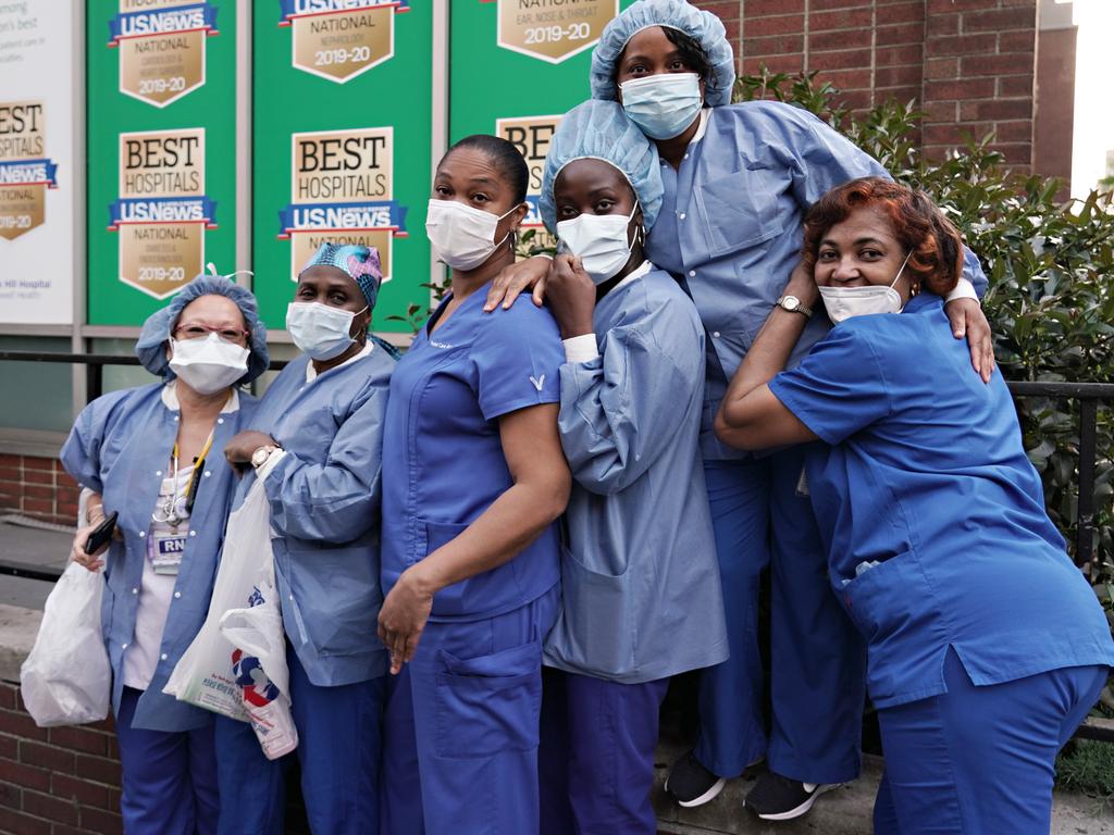 What is the new normal? Medical workers in New York City pose for a photo as people cheer to show gratitude to medical and frontline workers. Picture: Cindy Ord/Getty Images