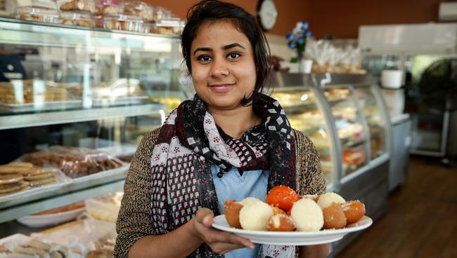 Lucky Fatema with some of the Bengali desserts at Dhaka Delight in Lakemba. Picture: Jonathan Ng