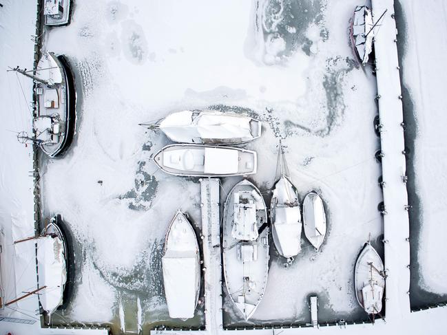 Picture taken with a drone shows snow-covered sailing ships mooring at the boatyard harbour of Kirchdorf on the Baltic Sea island of Poel, northeastern Germany, where bays risk to freeze due to permafrost and night temperatures below minus ten degrees Celsius, on February 27, 2018. A blast of Siberian weather dubbed “The Beast from the East” sent temperatures plunging across much of Europe. Picture: AFP