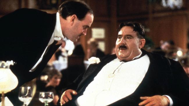 Terry Jones as Mr Creosote, with John Cleese as the waiter.