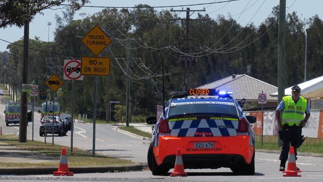 A police roadblock at the southern end of Minnesota Rd at the intersection of the Pacific Highway, Hamlyn Terrace, following a police pursuit and shooting. Picture: Richard Noone