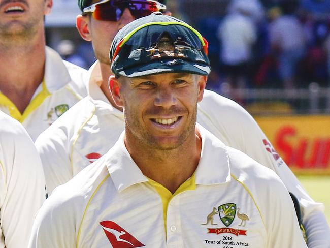 FILE - In this Monday, March 12, 2018 file photo, Australia's David Warner, right, leads his team off the field after losing the second cricket test between South Africa and Australia at St. George's Park in Port Elizabeth, South Africa. It was the new David Warner who arrived in South Africa a month ago. It was the old Warner who left, ostracized again, friendless in cricket, and in danger of no redemption this time. Maybe the state of cricket must also take some blame for allowing Warner to be worn down by one of the most abrasive, ill-tempered series the game has seen in years. (AP Photo/Michael Sheehan, file)