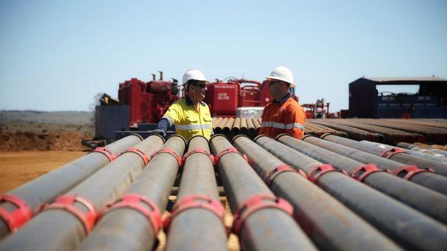 State Minister for Mines Dr Anthony Lynham (left), with an Origin worker. Picture: Contributed