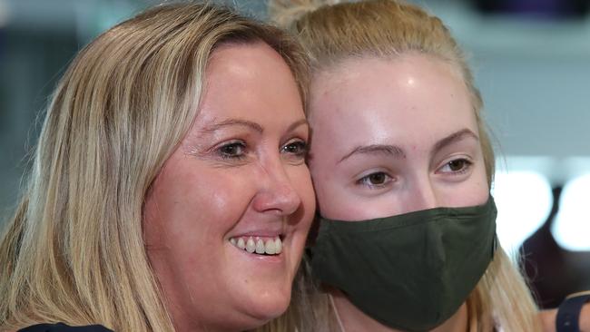 Helen Baxter greets her daughter Holly after she arrived on the first flight from Melbourne since the Queensland border reopened on December 1. Picture: Jono Searle/Getty Images