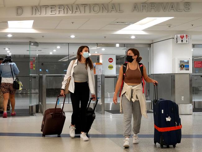 MIAMI, FLORIDA - SEPTEMBER 20: Travelers exit from the International arrivals door at Miami International Airport on September 20, 2021 in Miami, Florida. The U.S. government announced that it will ease airline restrictions on travel into the United States for people who have vaccination proof and a negative COVID-19 test.   Joe Raedle/Getty Images/AFP == FOR NEWSPAPERS, INTERNET, TELCOS & TELEVISION USE ONLY ==