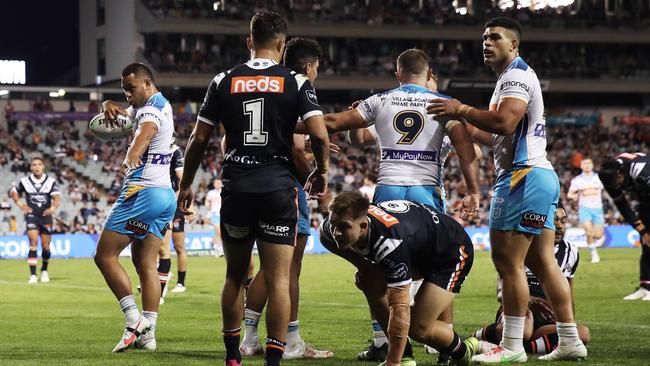 Phillip Sami (left) celebrates scoring a try in the Titans’ win against Wests Tigers. Picture: Matt King/Getty Images