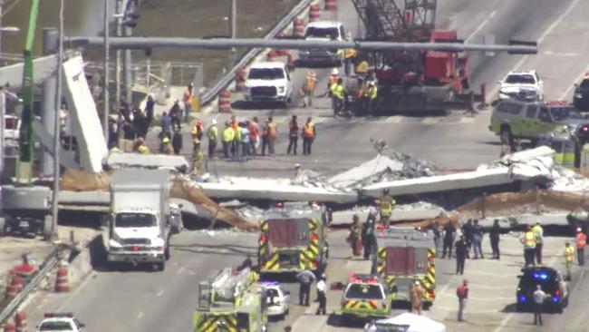 Emergency personnel work at the scene of a collapsed bridge in the Miami area. Picture: AP.