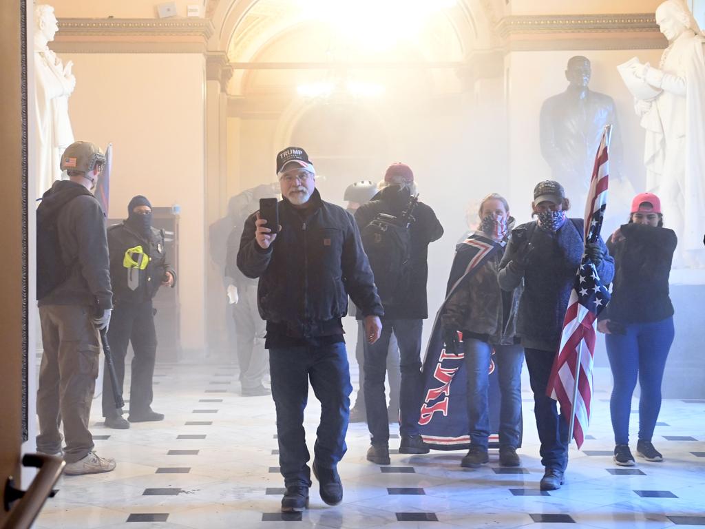 Supporters of US President Donald Trump enter the US Capitol as tear gas fills the corridor on January 6, 2021, in Washington, DC. Picture: AFP