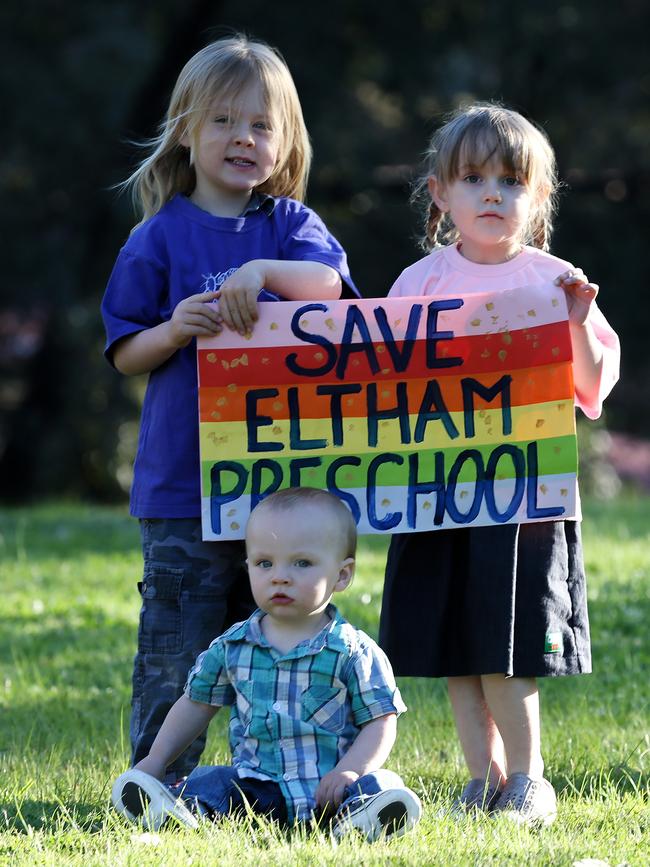 The Eltham community want security on the future of their much-loved preschool. Idris and Pippa hold a save Eltham preschool sign, with Bryn sitting. Picture: George Salpigtidis. 