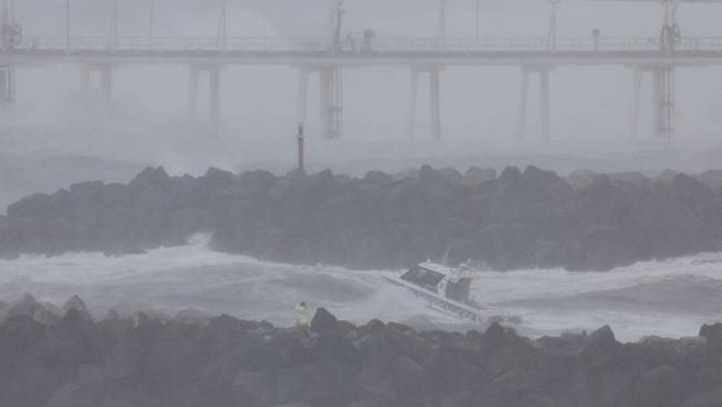 A police boat looks for a jet ski rider who went missing amid record-breaking waves in Coolangatta (Photo by David GRAY / AFP)