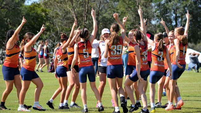 Players in WestMAC's undefeated 8A touch football team celebrate their 2021 TAS success.